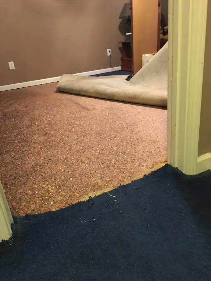Carpet pad removal revealing water damage during Drying & Dehumidification in Salem